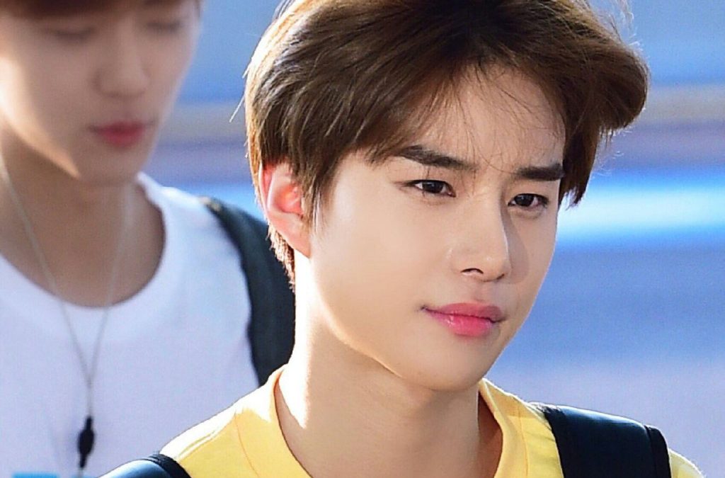 NCT's Jungwoo presents his eau de parfum to a fan in an adorable gesture