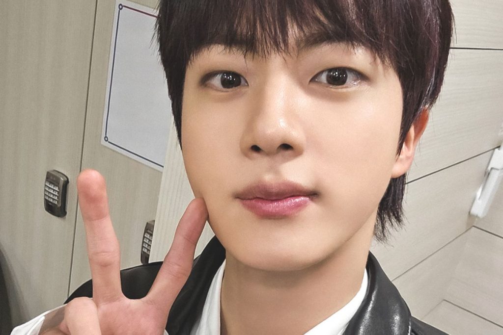 BTS’ Jin serves face and looks at the airport