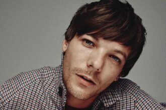 One Direction’s Louis Tomlinson says “What Makes You Beautiful” felt corny to perform