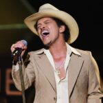 Bruno Mars reveals he is 'debt-free' during a concert in the United States