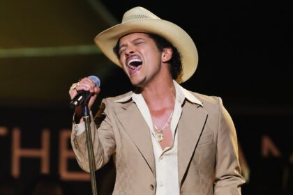 Bruno Mars reveals he is 'debt-free' during a concert in the United States