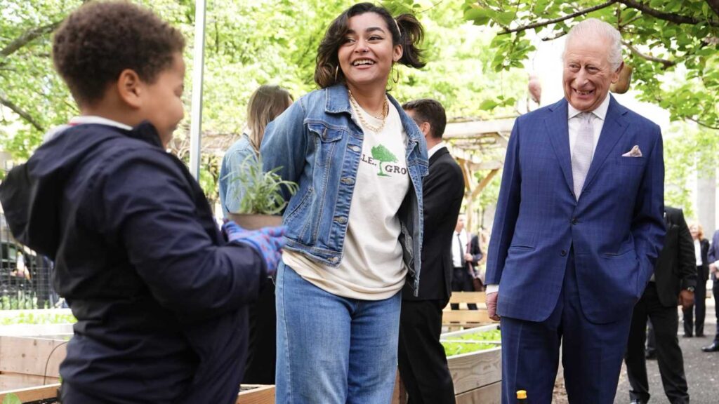 King Charles receives a hair compliment from a child during his Harlem visit
