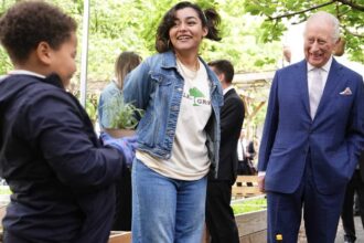 King Charles receives a hair compliment from a child during his Harlem visit