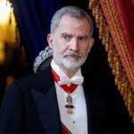The Spanish flag falls in front of King Felipe VI during a commemorative event