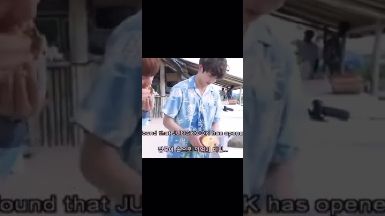 Jungkook peeling a pineapple with his hands
